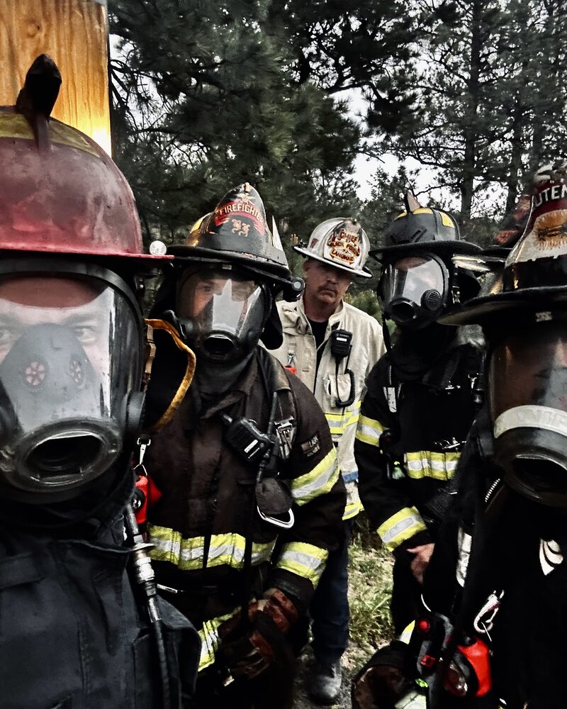 Firefighter breaching a training container prop on camera, behind the scenes of Mind Shift fire service production
