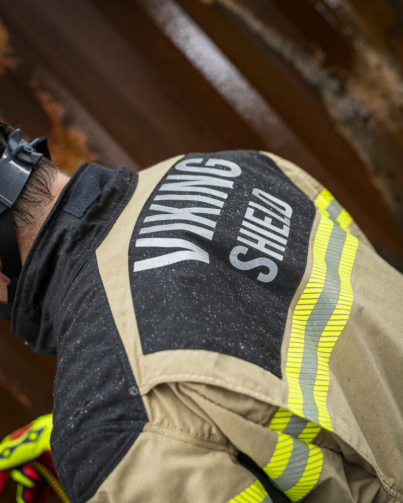 Close-up detail of firefighter turnout gear and helmet, fire service photography by Mind Shift