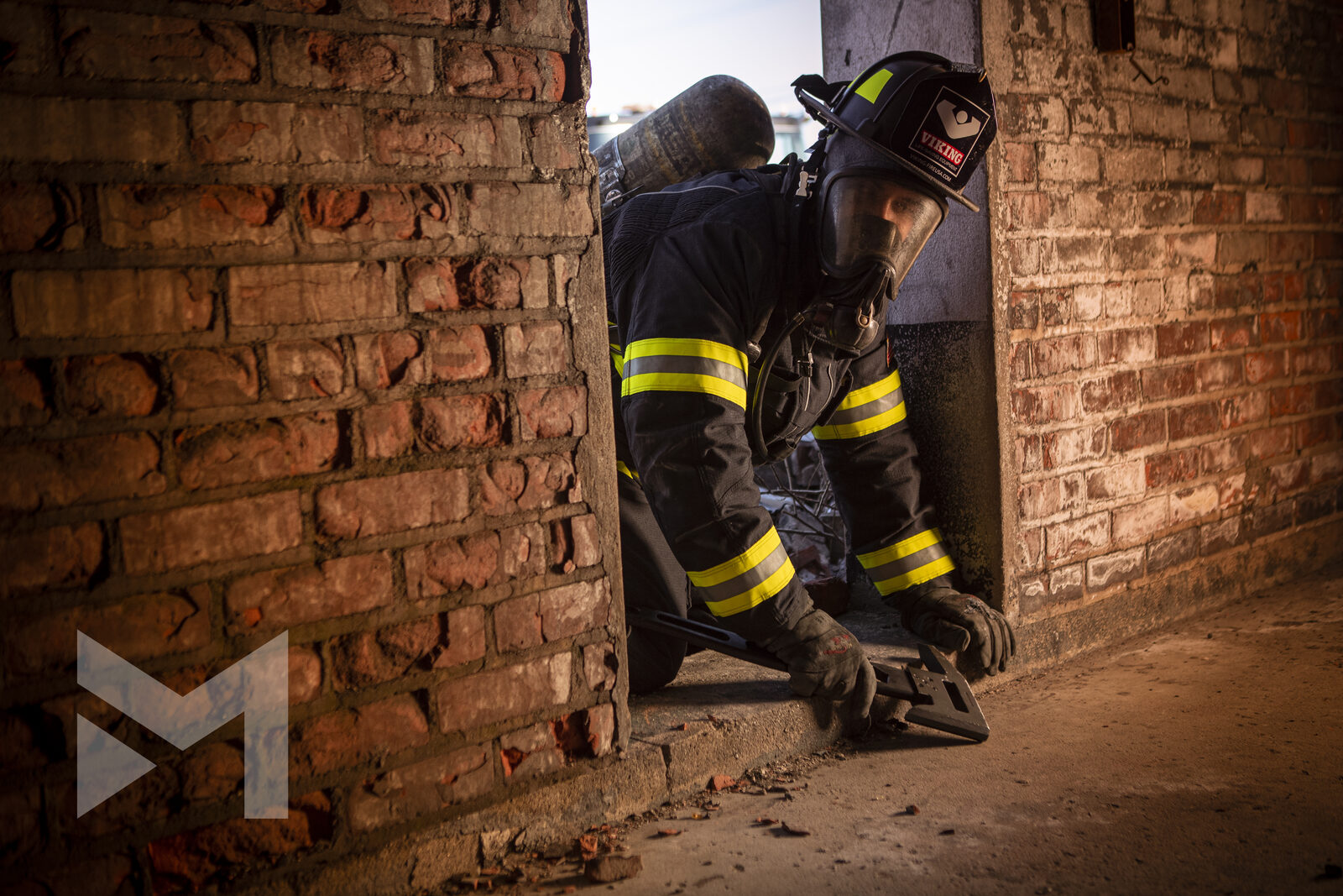 Firefighter crouching to force a doorway during forcible-entry training, fire service photography by Mind Shift