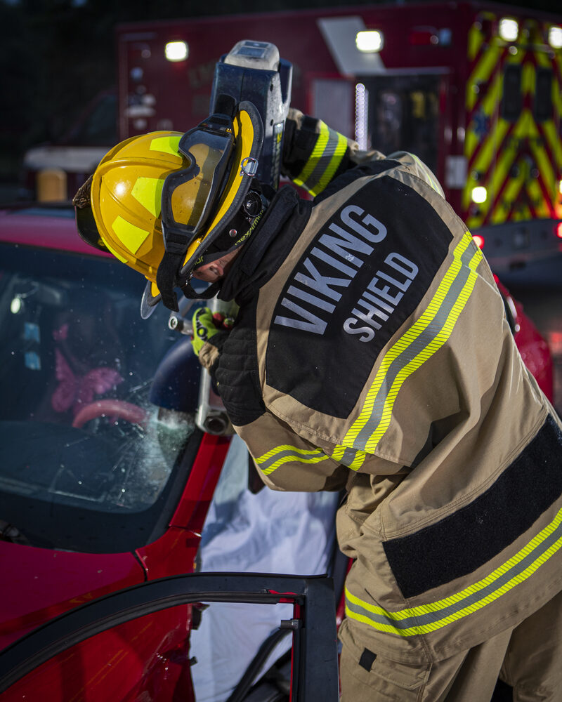 Firefighter working a nighttime vehicle extrication, cinematic fire service photography by Mind Shift