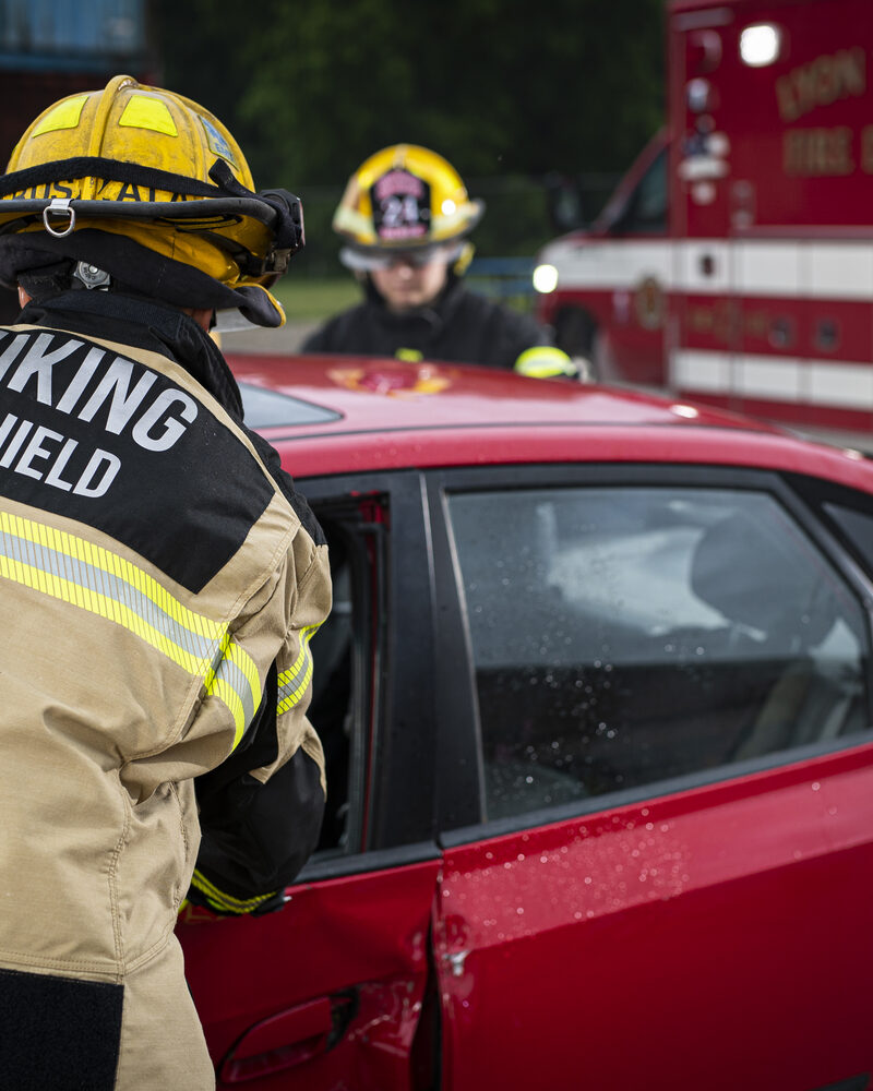 Firefighter performing a vehicle extrication rescue, firefighter photography by Mind Shift