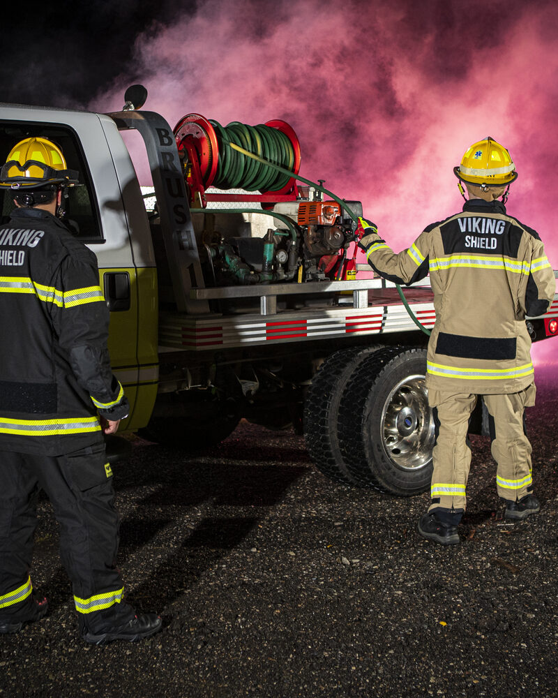 Firefighters working a brush truck in heavy smoke, wildland fire service photography by Mind Shift