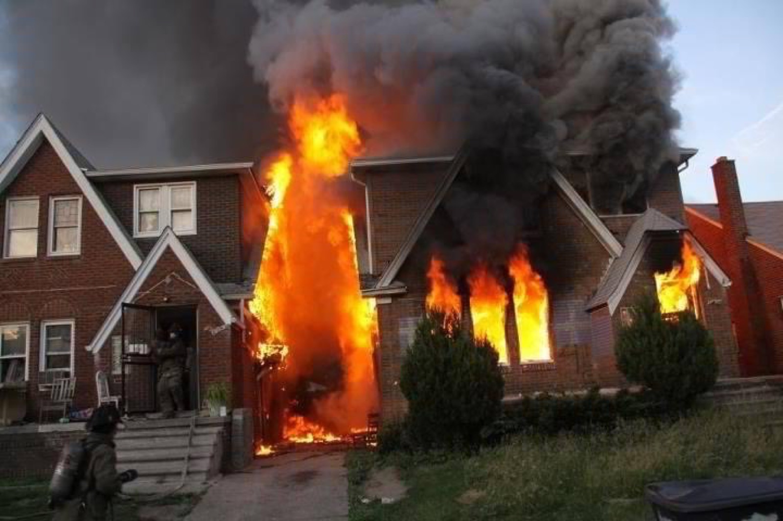 Detroit house fully engulfed in flames with firefighters on scene during BURN X