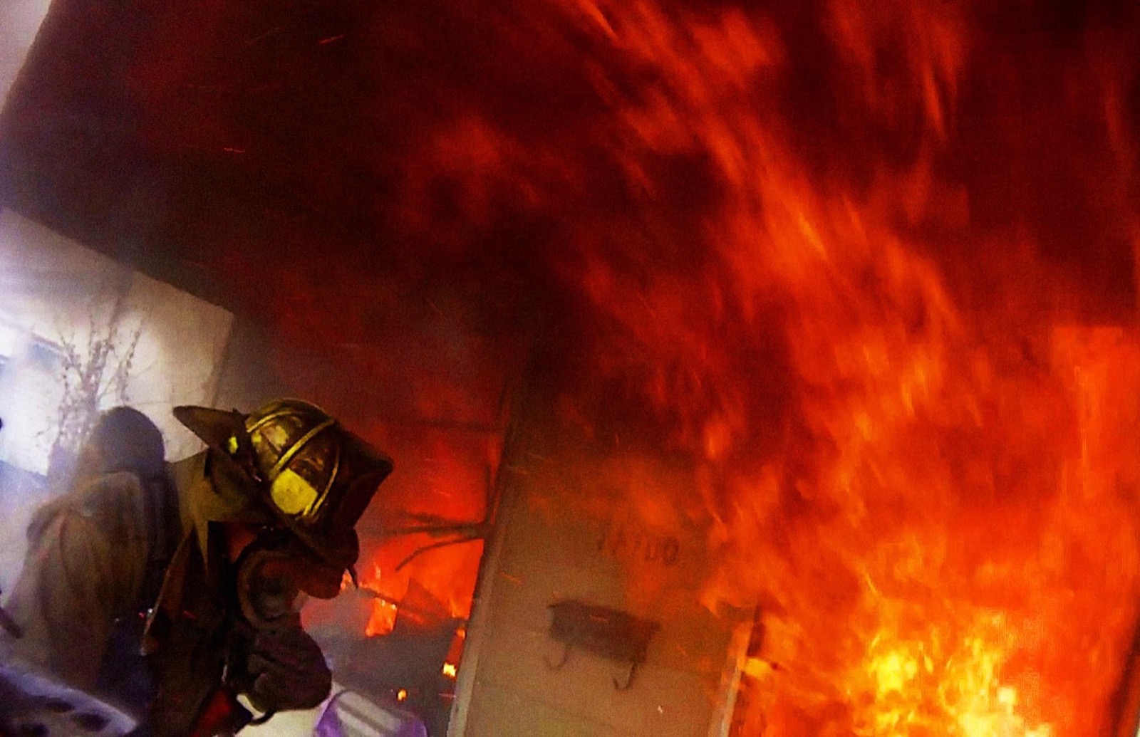 Detroit firefighter inside a structure engulfed in flames during BURN